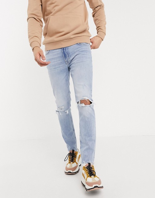 Bershka skinny jeans with knee rips in light blue wash