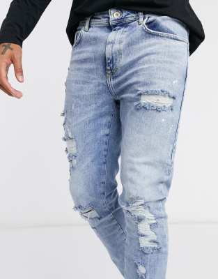 blue ripped jeans paint splatter