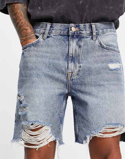 Bershka slim fit denim shorts with rips in blue