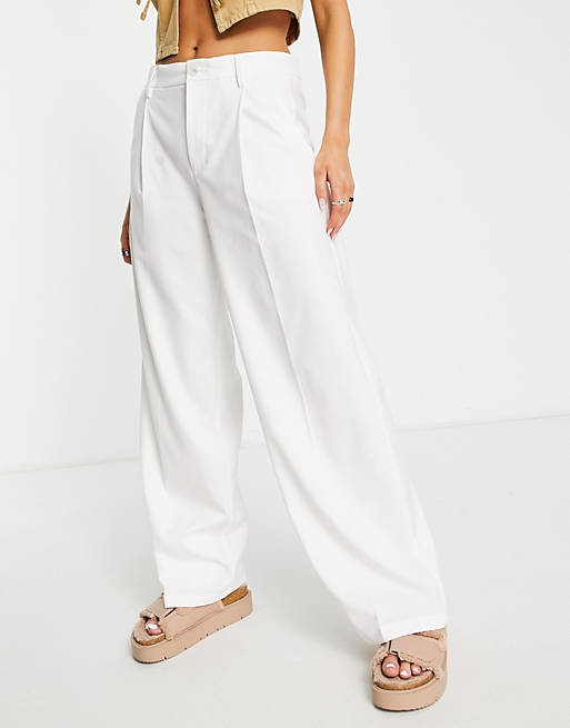 Bershka slouchy low waist tailored pants in white | ASOS