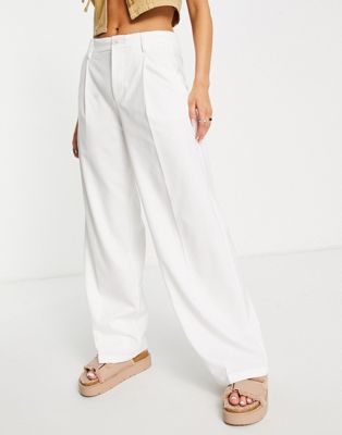 Bershka slouchy low waist tailored pants in white | ASOS