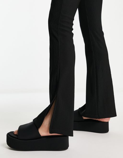 Rebellious Fashion slit front flared pants in black