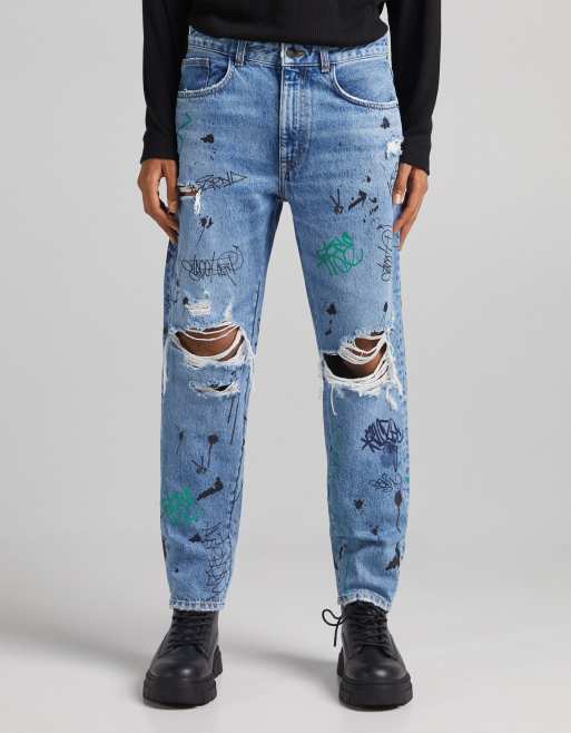 Bershka straight ripped jeans with graffiti print in blue | ASOS