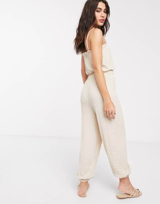 Bershka strappy crinkle jumpsuit in beige ASOS