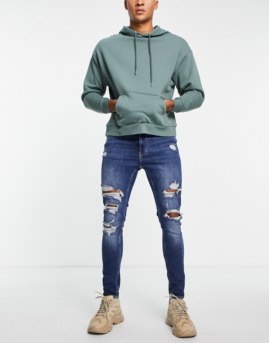 Bershka - Super skinny jeans met scheuren en gerafelde zoom in blauw