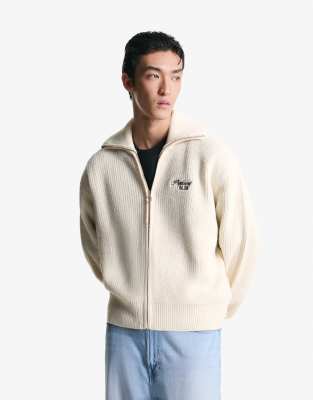 Bershka - Sweat brodé en tissu texturé à fermeture éclair - Blanc