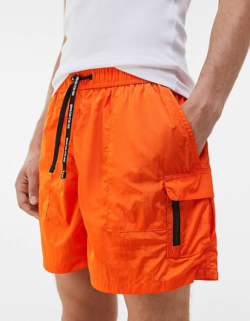 Bershka swim shorts with cargo pockets in orange