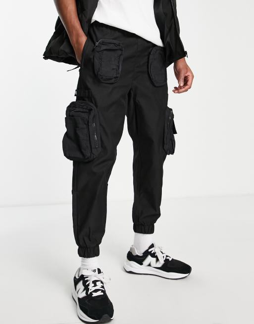 Bershka utility cargo pants with pockets in black