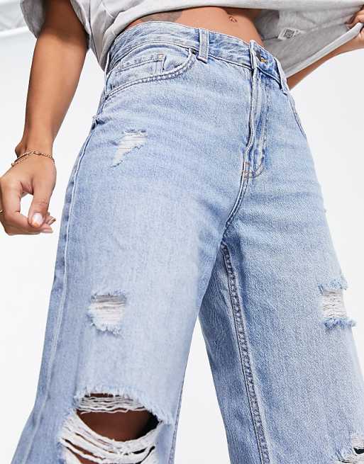 Bershka wide leg 90s jeans with exaggerated rips in mid blue Bershka wide leg 90s jeans with exaggerated rips in mid blue