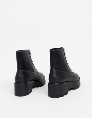 black boots with studs around sole