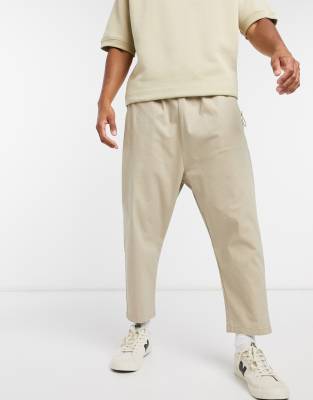 Брюки и чиносы Бежевые чиносы с низким шаговым швом ASOS DESIGN-Бежевый