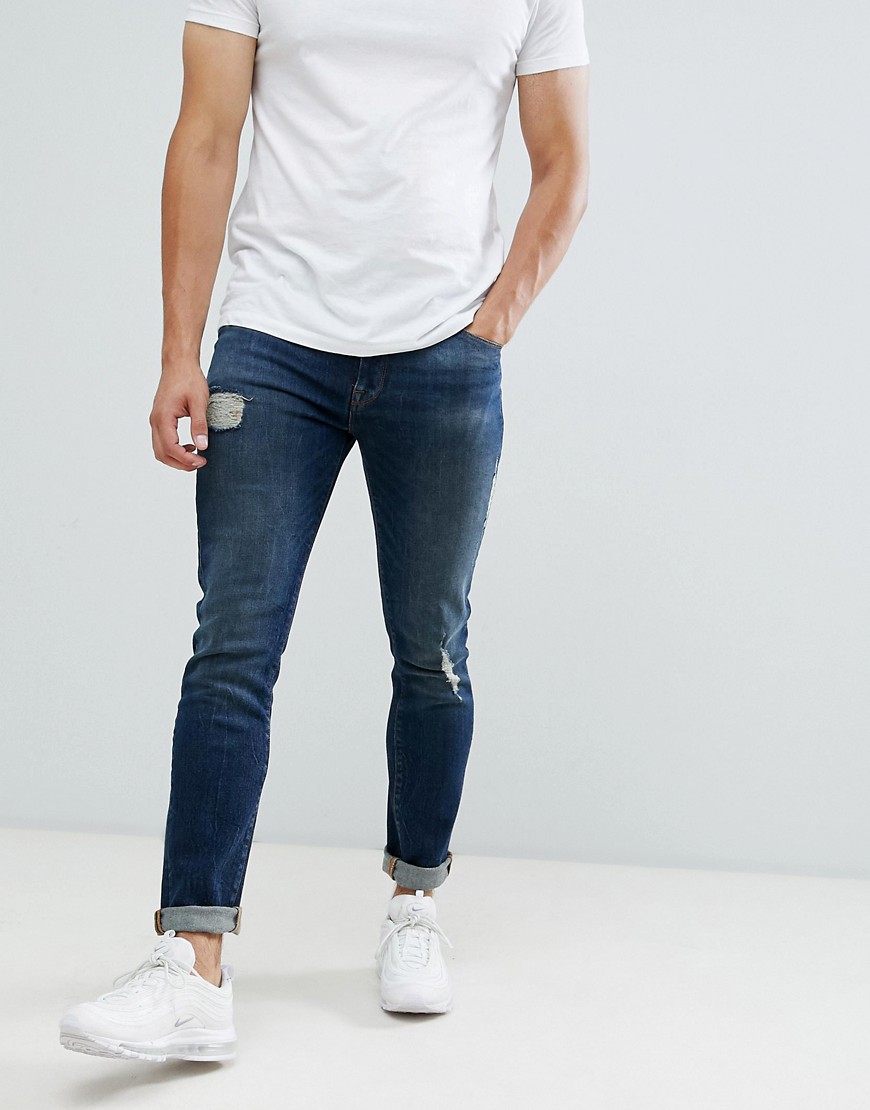 Blå mørkvaskede 12,5 oz skinny jeans med flænger og slidmærker fra ASOS DESIGN