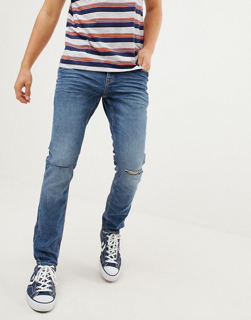 Blåvaskede skinny fit jeans i vintage model med stræk og huller på knærne fra Esprit