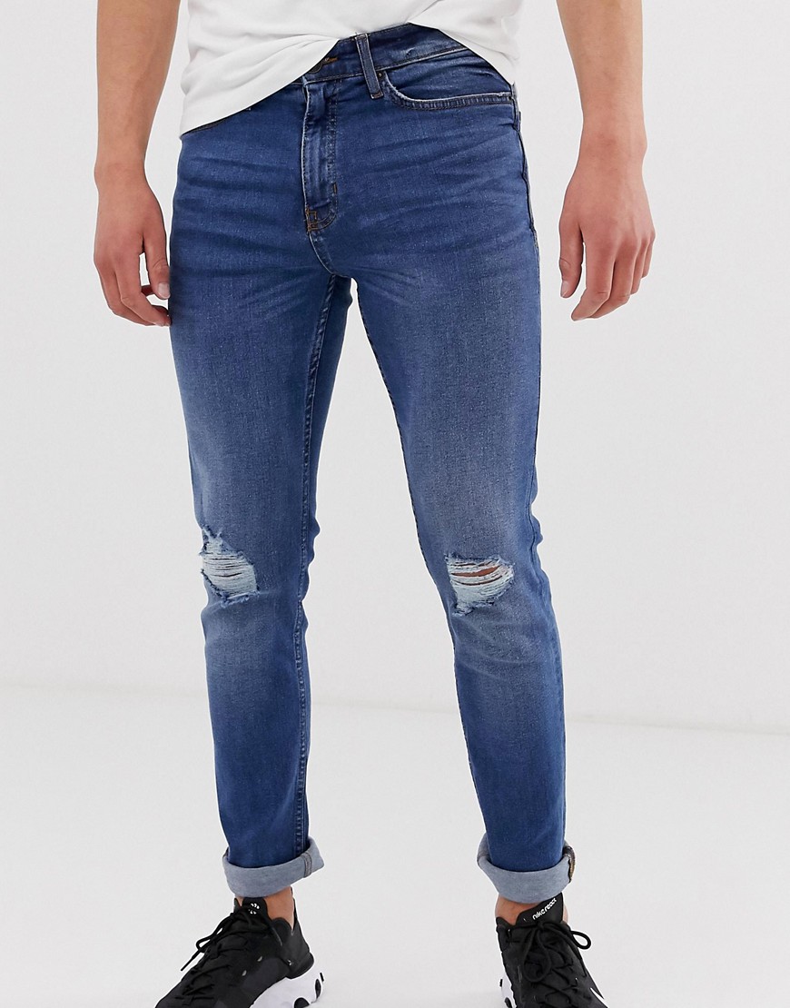 Blåvaskede skinny jeans med flænger på knæene fra New Look
