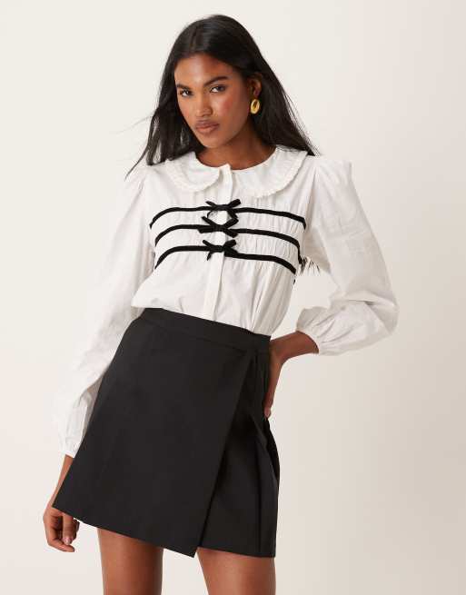 Blusa blanca con ribetes con lazos de terciopelo de Neon Rose