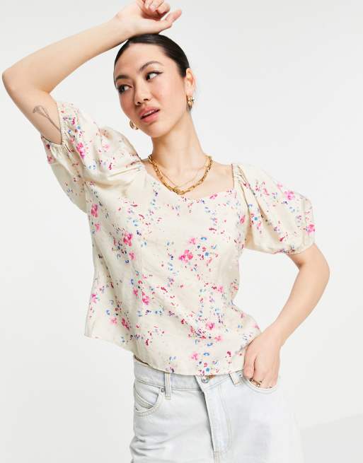 Blusa color crema de mangas abullonadaa con lazada en la espalda y estampado floral de Vero Moda