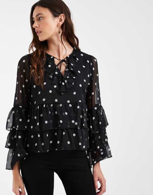 blusa trasparente con dettagli a volant a pois neri