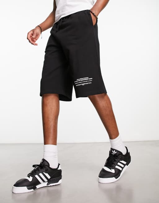 Boardshorts negros de corte alargado de COLLUSION