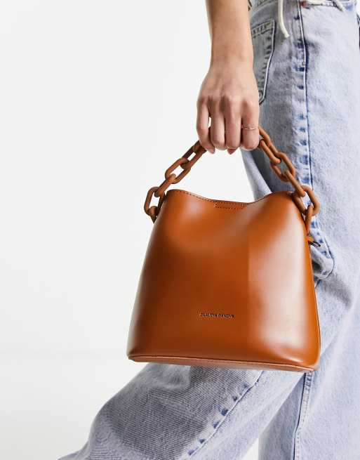 Bolso bombonera color tostado con detalle de cadena en el mismo tono de Claudia Canova