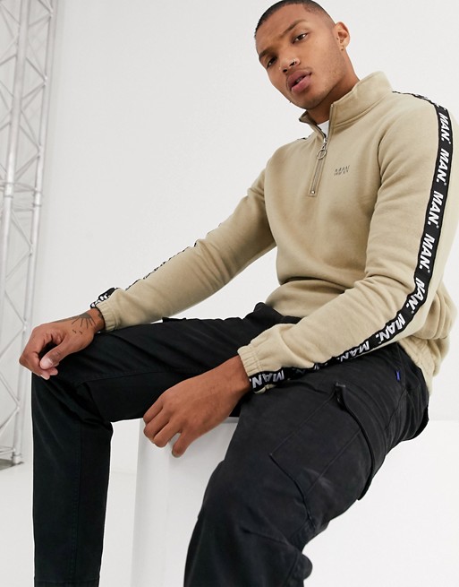 boohooMAN 1/4 funnel neck track top with man piping in stone
