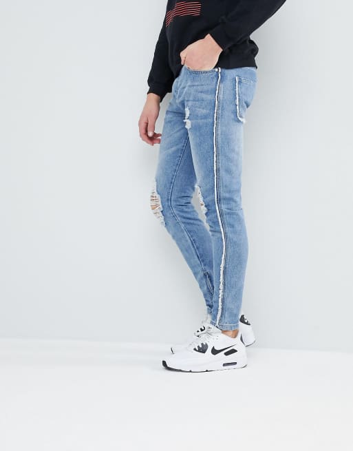 boohooMAN Jeans skinny blu délavé con cuciture grezze e zip sul