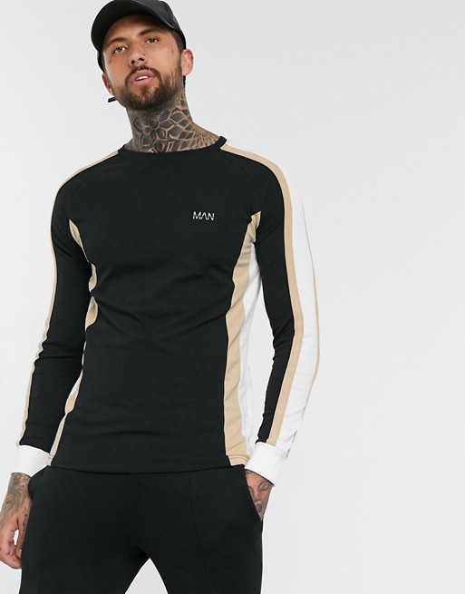 boohooMAN muscle fit long sleeve top with cut and sew panels in black