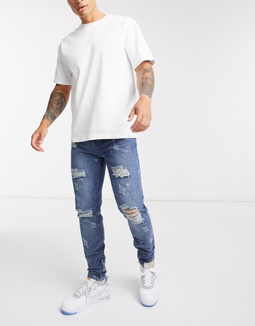 boohooMAN ripped skinny jeans with bleach splatter in mid wash blue