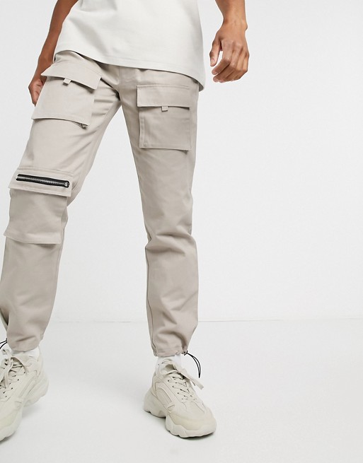 boohooMAN slim fit cuffed cargo trousers with drawcord in stone
