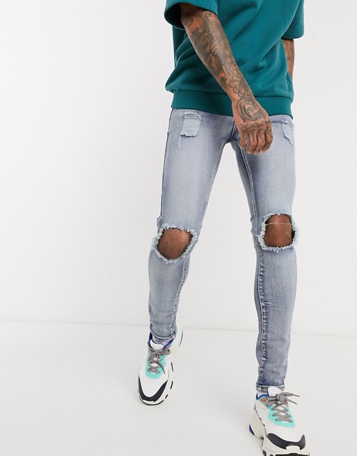 boohooMAN super skinny jeans with busted knee distressing in light blue