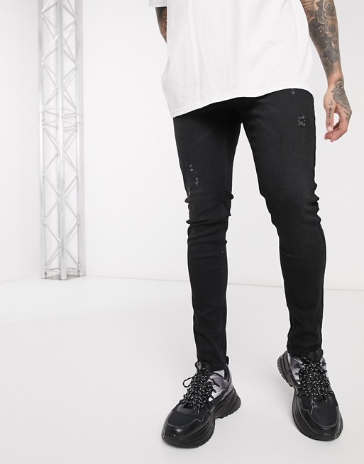 boohooMAN washed black skinny fit jeans with subtle distressing in black