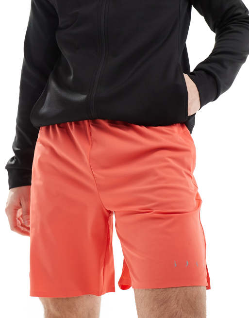 Born Living Yoga - Orinoco - Hardloopshort met zijzakken in koraal