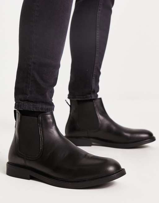 Botines Chelsea negros con diseño minimalista de cuero de Red Tape