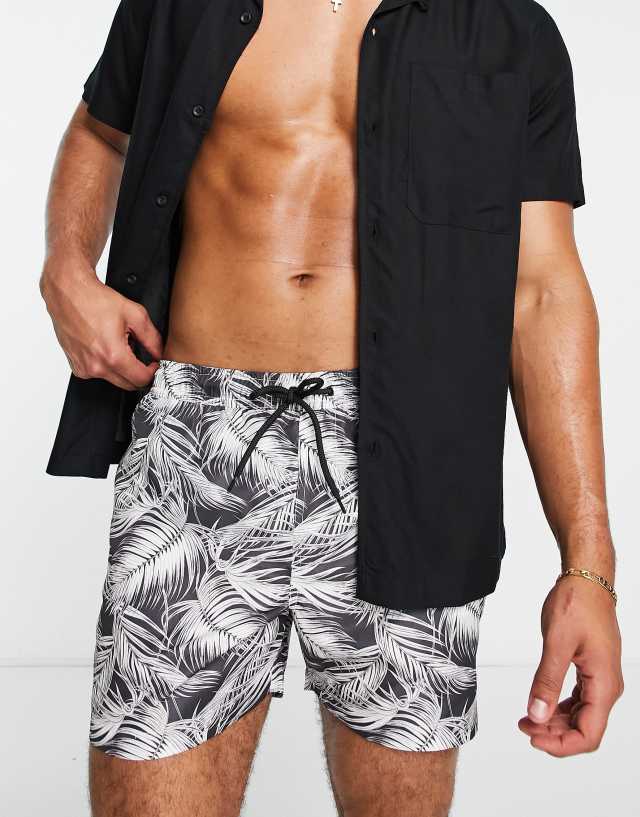 Brave Soul swim shorts in black with leaf print