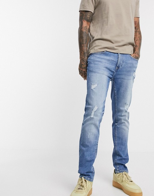 Burton Menswear tapered jeans with rips in light blue vintage wash