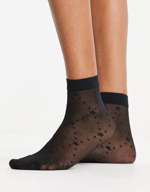 Calcetines negros con diseño de estrellas y lunares de tejido transparente de ASOS DESIGN