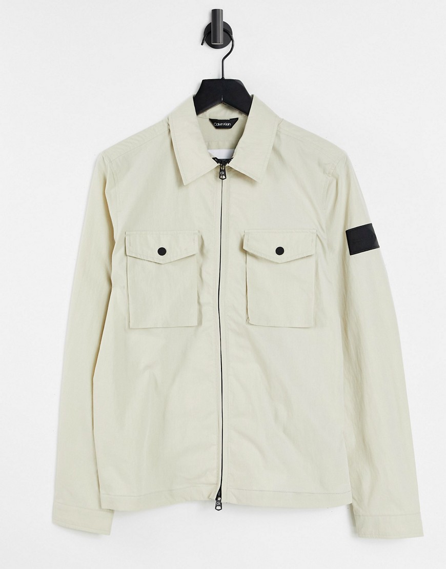Calvin Klein badge logo 2 pocket zip front shirt jacket in bleached stone-Neutral