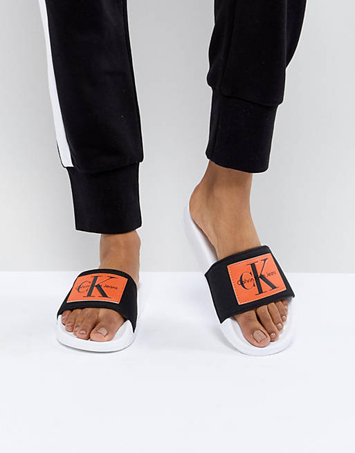 Calvin Klein Chloe Black and Orange Sliders | ASOS