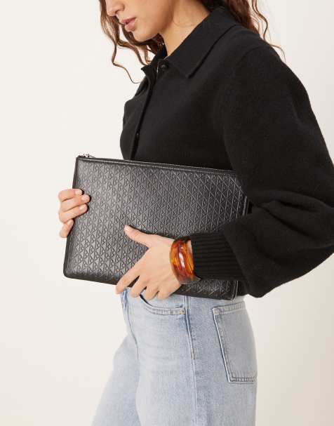 Calvin Klein emblem embossed pouch in black - view 1