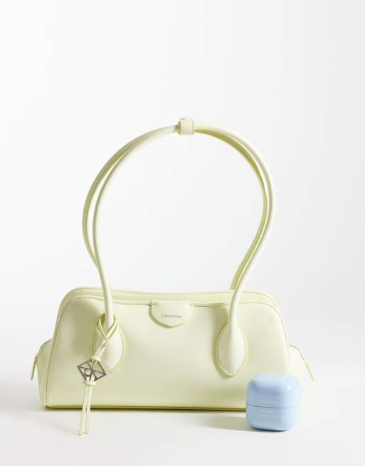 Calvin Klein emblem grain texture shoulder bag with hardware charm in pale yellow, 2 of 4