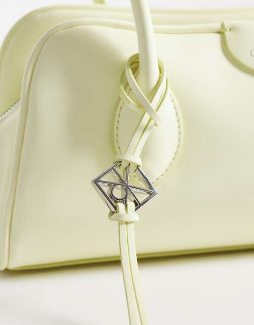 Calvin Klein emblem grain texture shoulder bag with hardware charm in pale yellow, 3 of 4