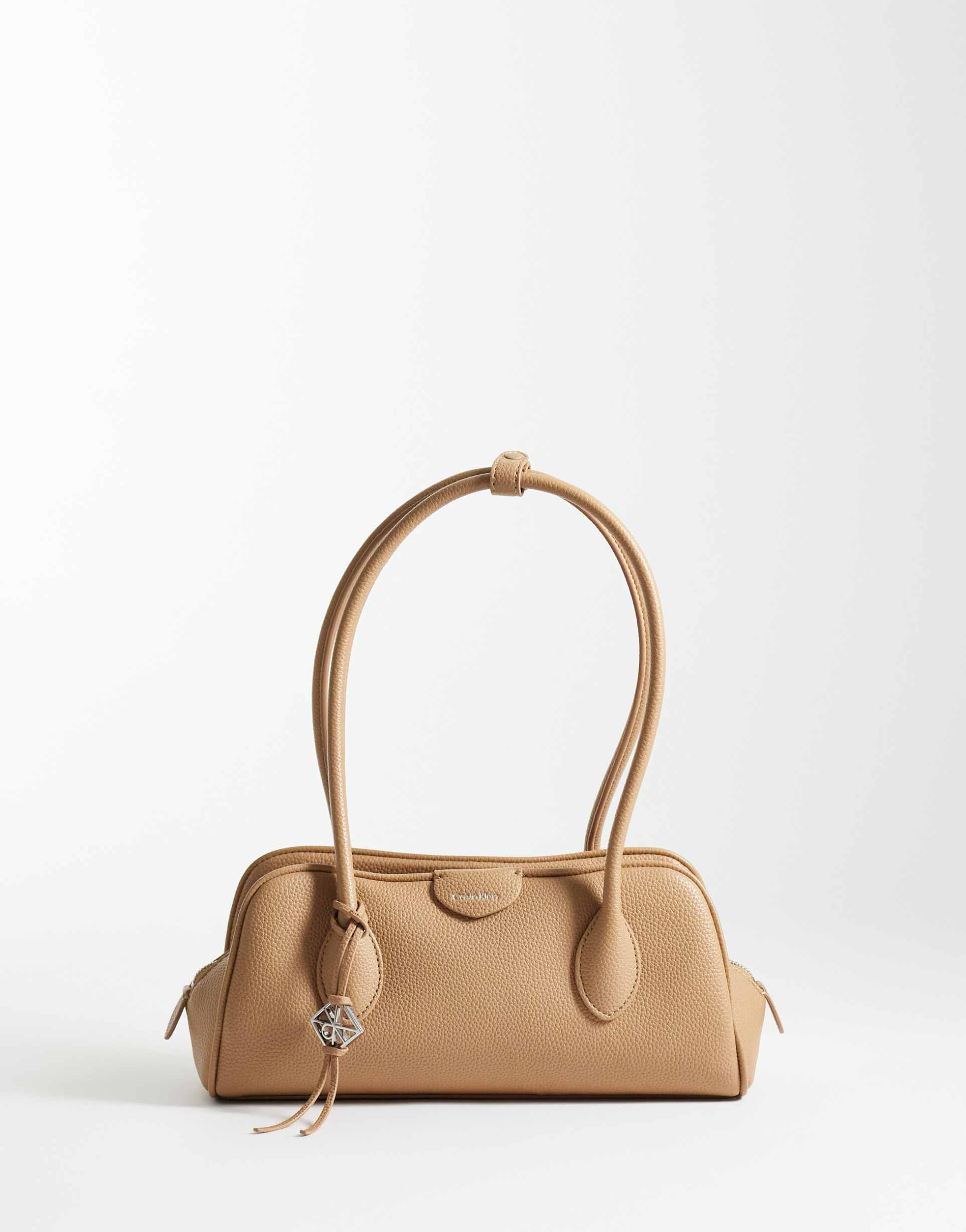 calvin klein emblem pebble shoulder bag with hardware charm in tan