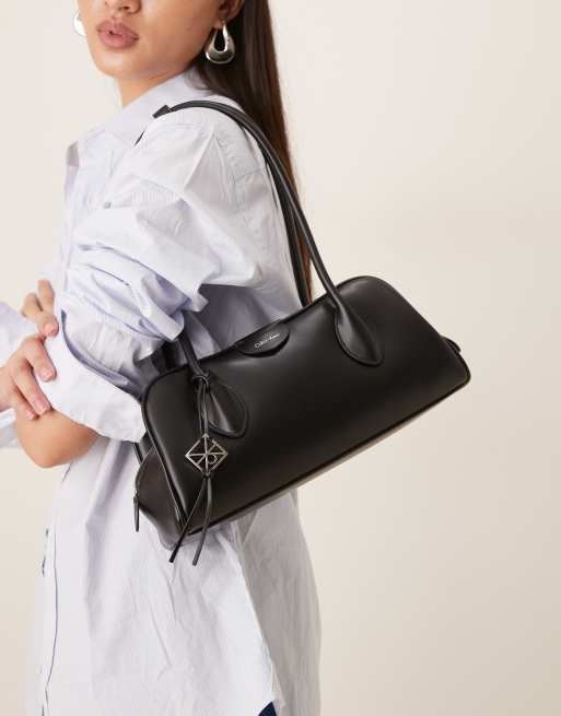 Calvin Klein emblem shoulder bag with hardware charm and grain texture in black, 2 of 4