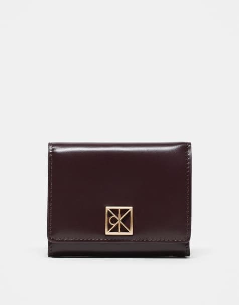 Calvin Klein emblem wallet with gold hardware in burgundy - view 1