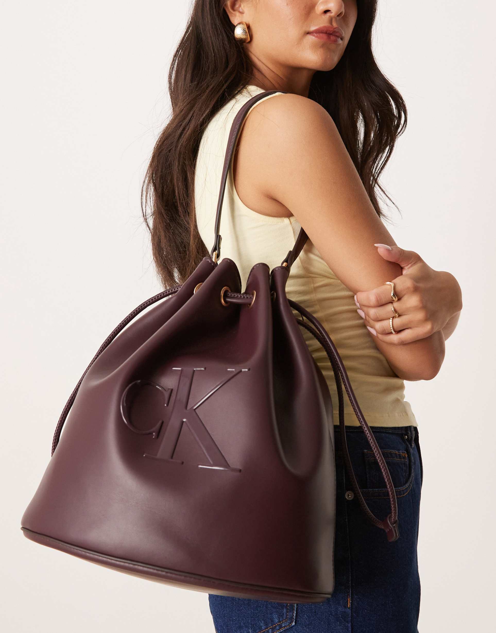 calvin klein embossed ck bucket bag in burgundy