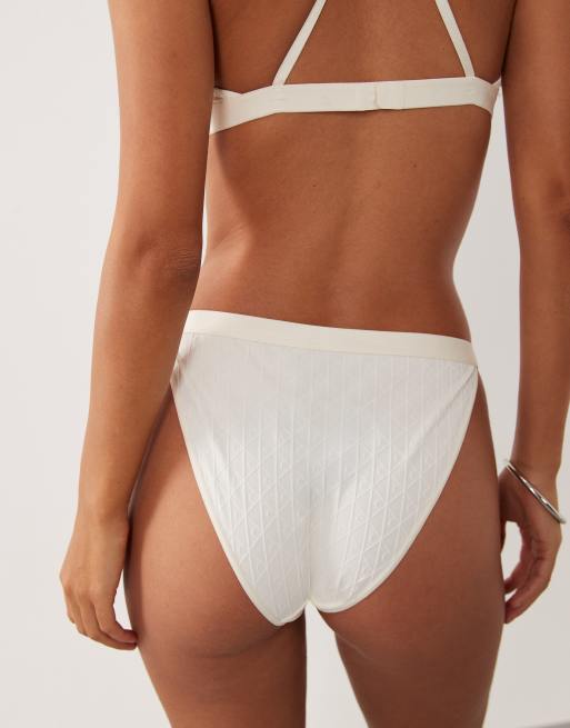 Calvin Klein embossed emblem bikini brief in ivory, 4 of 4