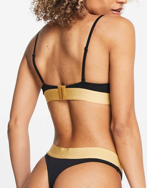 Calvin Klein Embossed Icon cotton blend thong in black and gold ASOS