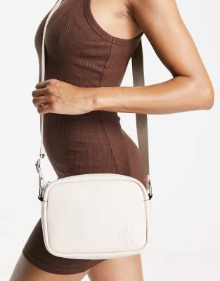 Calvin Klein faux | cream leather bag in camera ASOS