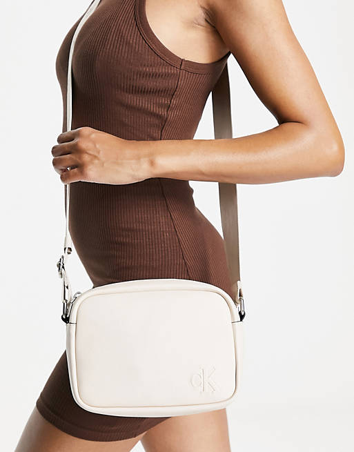 Calvin Klein faux leather camera bag in cream | ASOS