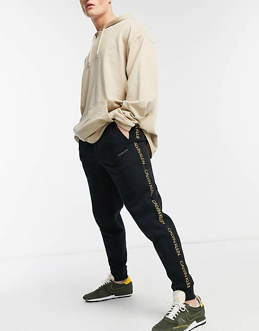 Calvin Klein gold capsule side tape logo cuffed sweatpants in black | ASOS | Stoffhosen