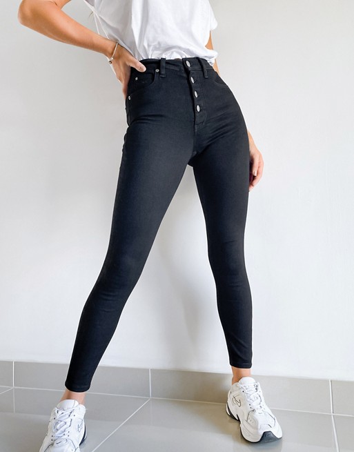 Calvin Klein high rise skinny jeans with exposed buttons in black